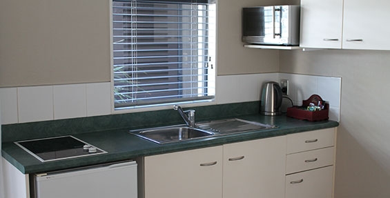 kitchenette with microwave, fridge and benchtop elements