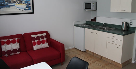 kitchen with cooktops, microwave and fridge